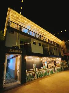 a large building with lights on it at night at Joaquinn's Bed and Breakfast in El Nido