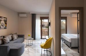 a living room with a couch and a bed at VagAthan - Lux Holidays in Afitos