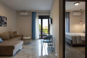 a living room with a couch and a bed at VagAthan - Lux Holidays in Afitos