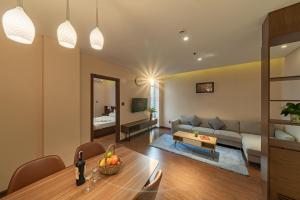 a living room with a couch and a table at DHTS Business Hotel & Apartment in Ho Chi Minh City