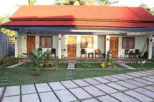 a small house with an orange roof at Room 212 in Kuta Lombok
