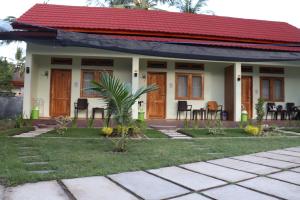a small house with a red roof at Room 212 in Kuta Lombok
