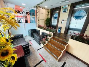 a lobby of a hotel with benches and flowers at Sky Hotel @ Pudu in Kuala Lumpur