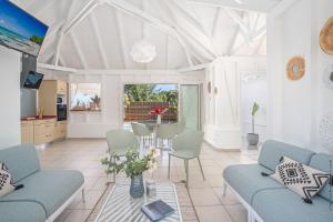 a living room with two blue couches and a table at PARADISE BAY in Le Robert