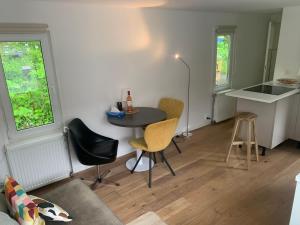 a small living room with a table and chairs at Tiny Houseboat B&B on the Amstel River in Amsterdam