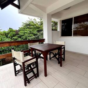 a wooden table and chairs on a porch at Angelina Villas_R1_Arte Casa_Malapascua in Logon