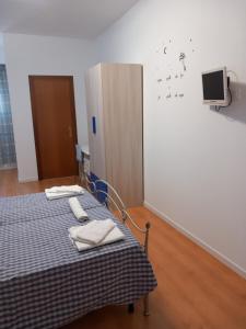 a hospital room with two beds and a tv on the wall at Dolce dormire in Fulgatore