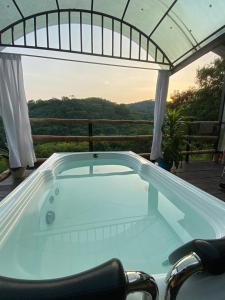 a jacuzzi tub on a deck with a view at Glamping girardot- finca la perla in Girardot