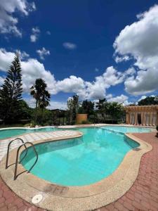 a large swimming pool with blue water in a courtyard at Spacious & Cozy 3BR House w/WIFI 