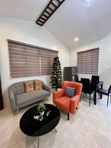 a living room with a christmas tree in the corner at Spacious & Cozy 3BR House w/WIFI 