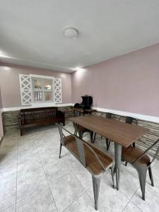 a dining room with tables and benches in a room at Spacious & Cozy 3BR House w/WIFI 