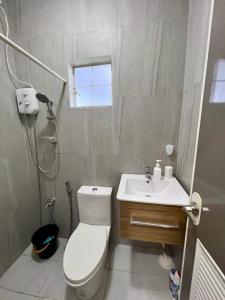 a bathroom with a toilet and a sink at Spacious & Cozy 3BR House w/WIFI 
