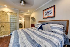 a bedroom with a large bed with blue and white sheets at Step into the French Quarter in New Orleans