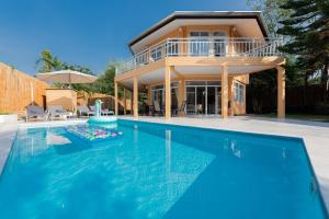 a house with a swimming pool in front of a house at Twin Villas Ao Nang in Ao Nang Beach