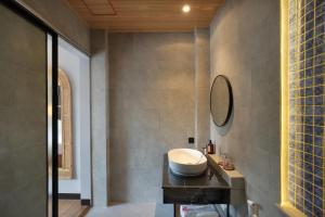 a bathroom with a sink and a mirror at Amandaya Canggu in Canggu