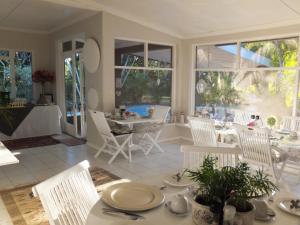 a dining room with white chairs and a table at St Lucia Kingfisher Lodge in St Lucia