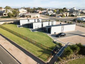 an aerial view of a white building with a green lawn at BIG4 Breeze Holiday Parks - Port Hughes in Port Hughes