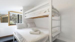 a white bunk bed with a towel on it in a room at Shamrock 8 in Mount Hotham