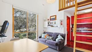 a living room with a couch and a table at Shamrock 8 in Mount Hotham