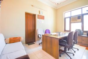 an office with a desk and chairs in a room at OYO Flagship 11 Inn in Ludhiana