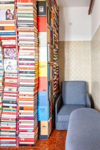 a room with a chair and a large stack of books at Book house 