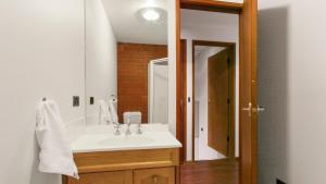 a bathroom with a white sink and a mirror at Brockhoff Lachen in Mount Hotham +13 photos