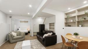 a living room with a table and chairs and a bed at Brockhoff Lachen in Mount Hotham
