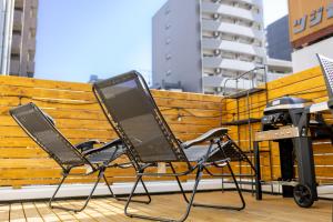 a laptop computer sitting on a chair on a balcony at ONE WORLD Sakaisuji Honmachi in Osaka