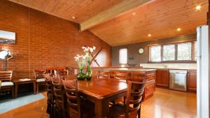 a kitchen and dining room with a wooden table and chairs at Lindsay Lachen in Mount Hotham