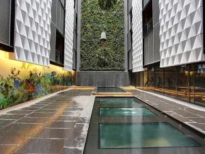 a swimming pool in the middle of a building at Luxe at Paris end Melbourne in Melbourne
