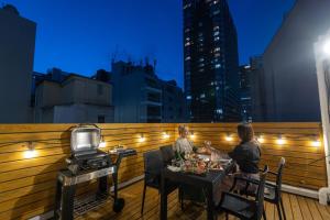 two people sitting at a table on a balcony at ONE WORLD Sakaisuji Honmachi in Osaka