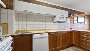 a kitchen with a sink and a white dishwasher at Lawlers 17 in Mount Hotham