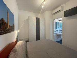 a bedroom with a bed and a bathroom at Casa Riviera in San Vito lo Capo
