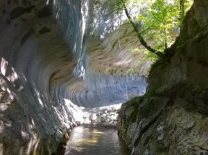 a cave with a river inside of it at Bubu Apartament in Petroşani