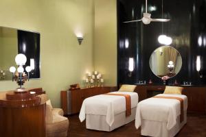 a bathroom with two beds and a mirror at Umaid Bhawan Palace Jodhpur in Jodhpur