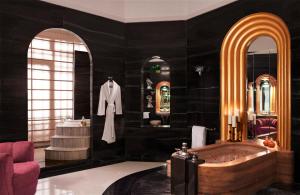 a black bathroom with a tub and a sink at Umaid Bhawan Palace Jodhpur in Jodhpur