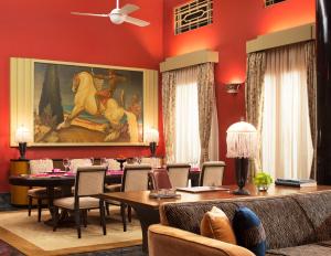 a dining room with a painting of a horse on the wall at Umaid Bhawan Palace Jodhpur in Jodhpur