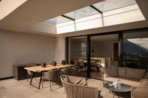 a living room with a table and chairs at View House - Chalet Goyen in Schenna