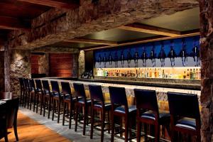 a bar with blue chairs in a restaurant at Bachelor Gulch Ritz-carlton 1 Bedroom Mountain Residence With Ski In, Ski Out Access, Hot Tub, And Full Service Spa in Avon