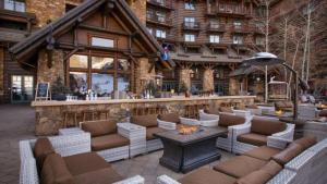 a lodge with a bar with couches and a fireplace at Bachelor Gulch Ritz-carlton 1 Bedroom Mountain Residence With Ski In, Ski Out Access, Hot Tub, And Full Service Spa in Avon