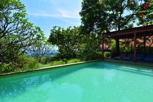 a swimming pool in a yard with a gazebo at Villa Sarah Nafi, amazing ocean views in Temukus