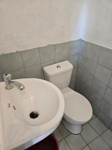 a bathroom with a white toilet and a sink at Antipolo Budget Hostel,Family Rooms in Antipolo