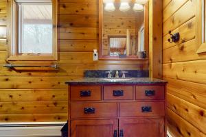 a bathroom with a sink in a log cabin at Mountain View Chalet in West Dover +54 photos
