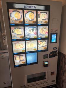a vending machine with food on the wall at Cycle Guest House SHIOKAZE in Setoda
