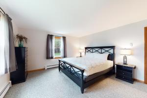 a bedroom with a black bed and a window at Neverending Lake Fun in Paris