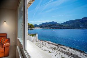 a room with a window looking out at the water at L'ODYSSÉE BLEUE VUE MER in Cassis