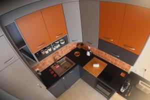 an overhead view of a small kitchen with brown cabinets at L'ODYSSÉE BLEUE VUE MER in Cassis