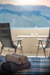 a pile of towels sitting on the floor next to a chair at L'ODYSSÉE BLEUE VUE MER in Cassis