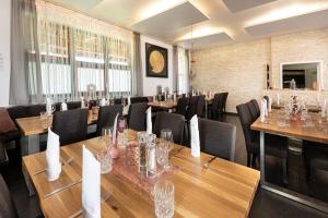 a dining room with wooden tables and chairs at Hotel Restaurant Zehn-Brunnen in Renningen