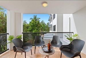 a group of chairs and a table on a balcony at Mirage Luxury Beachside 3 Bedroom Apartment in Alexandra Headland